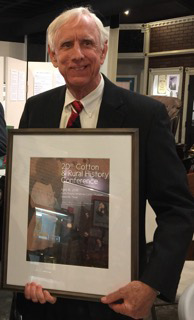 Dr. James Conrad receiving his award as the Hunt County Historical Commission and the sponsors of the 20th Cotton and Rural History Conference recognized him as one of the best archivists in Texas.